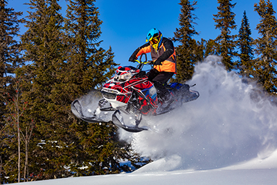 A man is riding snowmobile in mountains. Beautiful morning light B+B Thermo-Technik GmbH aus Donaueschingen, Baden-Württemberg in Deutschland. Sensorik und Messtechnik. Automobilbranche